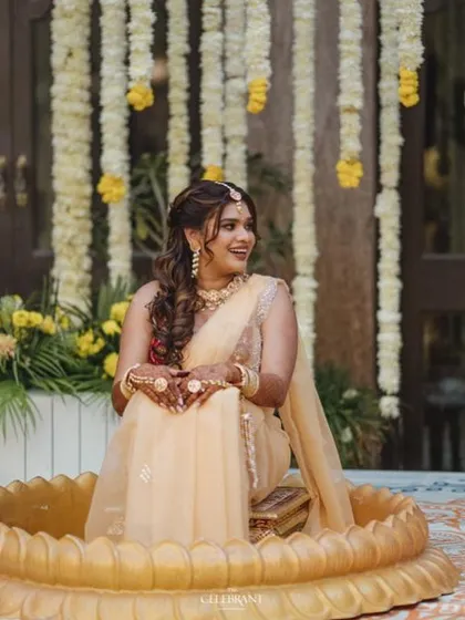A bride enjoying her Haldi ceremony in Jodhpur, wearing our delicate fresh floral accessories.