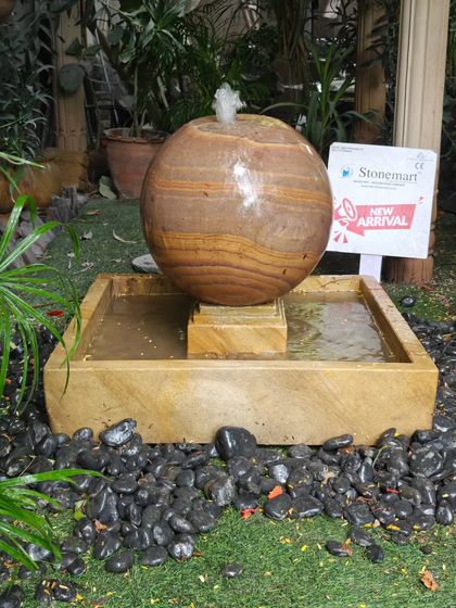 Another view of the sphere fountain, highlighting the wet stone which brings out the deep, rich colors of the Rainbow Sandstone.