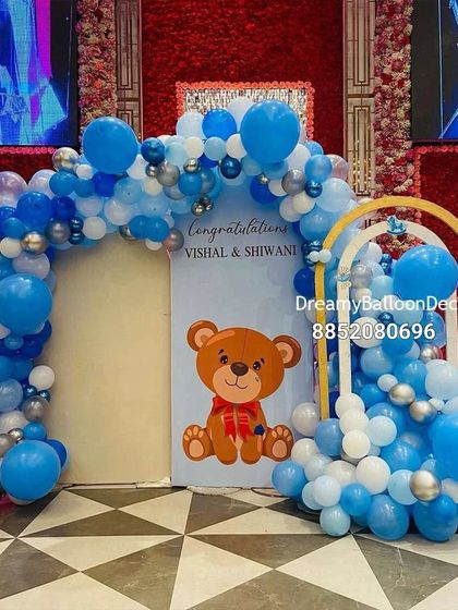 A cute teddy bear themed baby shower or welcome baby decoration. The blue and white balloon arch is perfect for a large venue or banquet hall.
