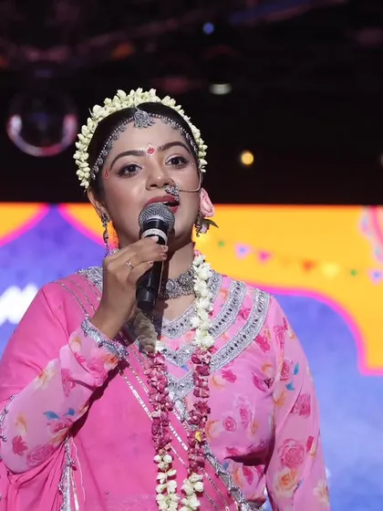 Another expressive hosting moment as Radha, connecting with the audience.