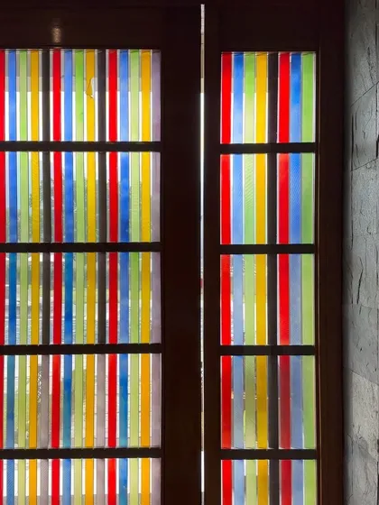 An ordinary door can become an extraordinary feature. For this project, I designed a custom door using strips of colored glass to create a vibrant, artistic statement piece that transforms the way light enters the space.