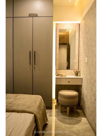 This parent's bedroom includes a simple, elegant dressing table nook. The design ensures that even smaller rooms have dedicated zones for different activities.