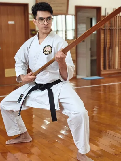 A senior student demonstrates a strong kamae (stance) with a Bo staff during our training trip to the Honbu Dojo in Okinawa.