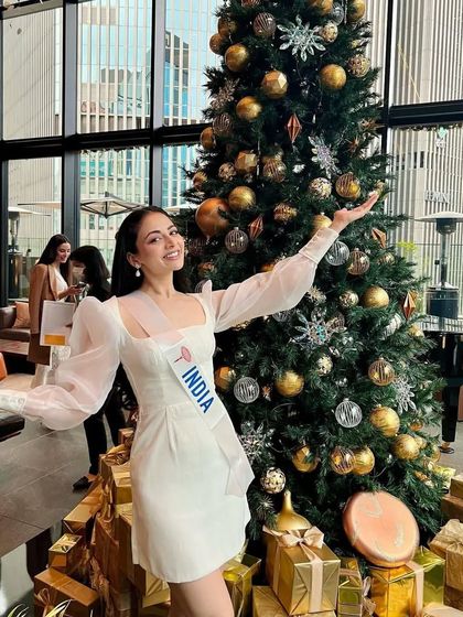 A festive shot of Zoya by the Christmas tree. Even in a more casual setting, the polished hair and makeup look impeccable.