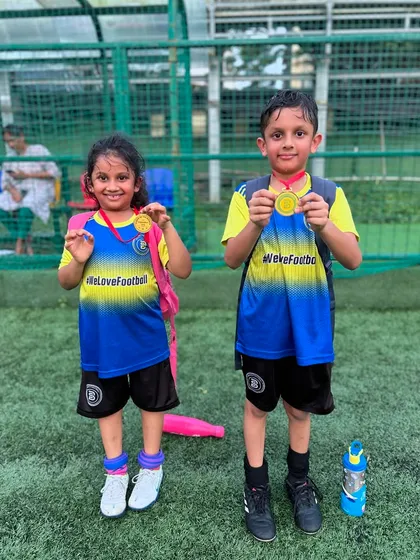 Two good. Siblings Hairah and Haider proudly show off their Player of the Month medals.