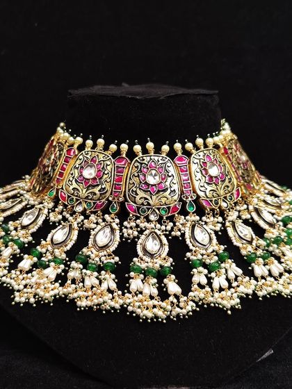 A beautiful meenakari choker with pearls and green beads.