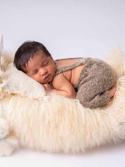 A slightly different pose on the bed, showing his tiny feet curled up. Every detail is worth capturing.