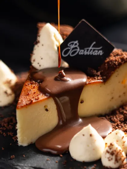 A moment of pure indulgence. For Bastian, we focused on capturing the decadent texture of their famous cheesecake, using a rich chocolate pour to create a dynamic and irresistible dessert photograph.