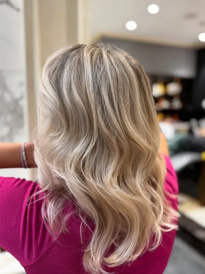 Another view of this pearl blond balayage, showing the seamless blend and soft waves.