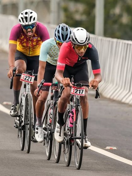 Three elite riders in a breakaway, working together to stay ahead of the chasing pack.