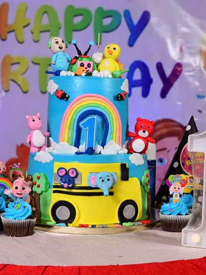 A closer look at the Cocomelon cake and matching cupcakes. These custom treats, featuring beloved characters, add a fun and edible element to the party's theme.