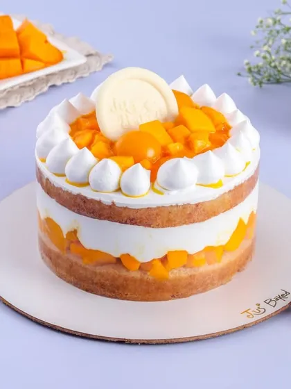 Another look at my popular Mango Vanilla cake. You can see the distinct layers of sponge, cream, and heaps of fresh mango, making it a light yet satisfying dessert.