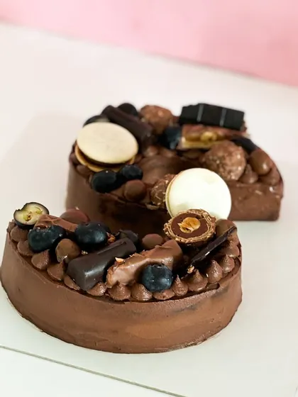 Say it with a cake that’s as unique as you are. My monogram cakes, like this one loaded with chocolate, macarons, and fresh blueberries, are a delicious way to personalize your celebration.