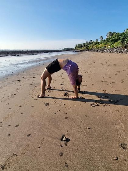 Backbend on the beach. Releasing pent-up emotions with a wheel pose is a therapeutic experience, especially with the sound of the waves.