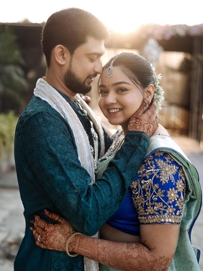 An intimate moment between the couple. The bride's radiant smile and glowing makeup are the highlights of this beautiful shot.