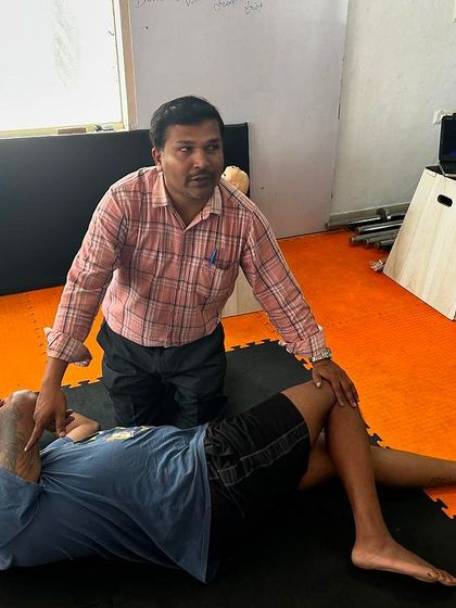 A student learning how to put an unconscious person in the recovery position to ensure their airway remains open.