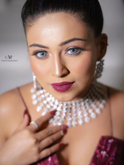 A striking close-up portrait of the bride on her engagement day, highlighting her flawless makeup and dazzling diamond jewelry.