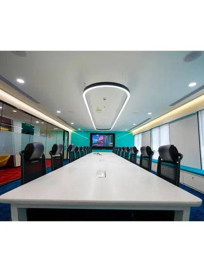 A state-of-the-art boardroom designed for Mindsprint. The space features a long conference table, integrated technology, and a custom overhead lighting fixture, creating a sophisticated and professional setting for critical meetings and presentations.