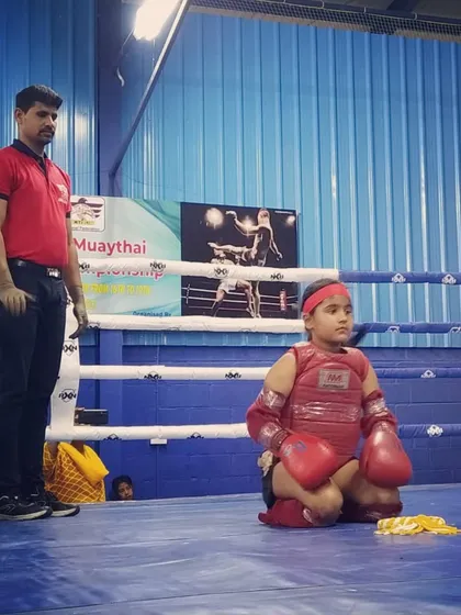A young fighter performs the Wai Kru Ram Muay, a traditional ritual before a Muay Thai fight. I teach my students the cultural traditions and respect that are central to this martial art.