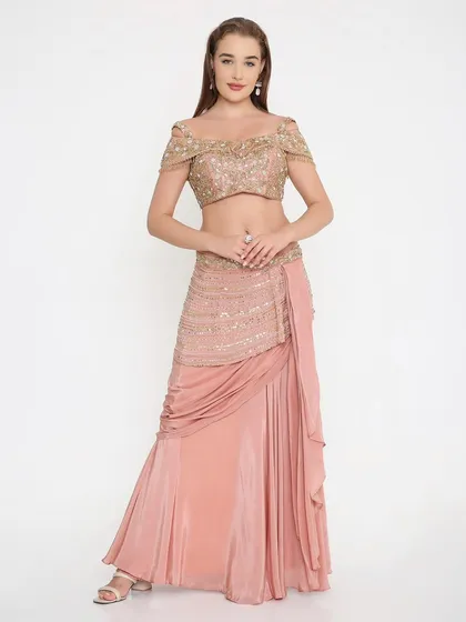 A full look at our custom-made soft peach draped outfit. The off-shoulder embroidered blouse and elegantly draped skirt create a silhouette that is both modern and graceful.