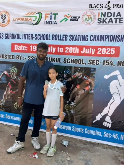 Celebrating an individual victory. One of our dedicated skaters proudly displays her silver medal next to the official banner of the SS Gurukul Inter-School Roller Skating Championship.