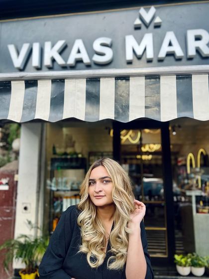 The client posing outside the salon with her new blonde look. A great hair color looks amazing both indoors and out in the natural light.