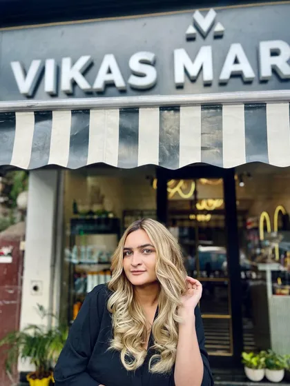 The client posing outside the salon with her new blonde look. A great hair color looks amazing both indoors and out in the natural light.
