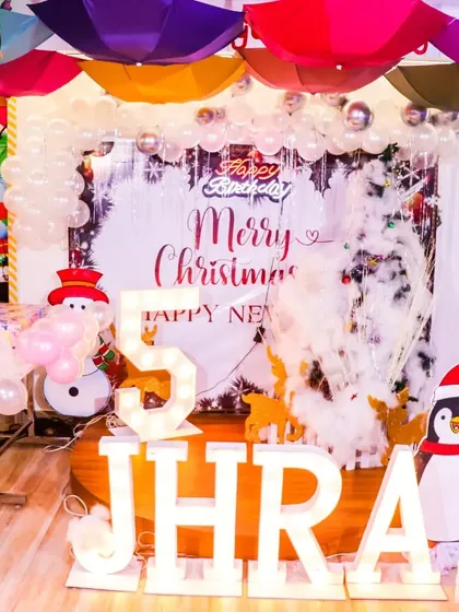I can create magical holiday-themed parties, like this winter wonderland celebration for a 5th birthday. The decor included a "Merry Christmas" backdrop, a snowman balloon figure, and a friendly penguin cutout to complete the festive scene.