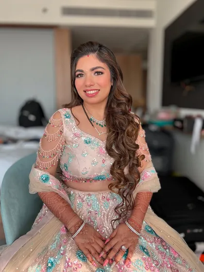 Another angle of Kejal's beautiful reception makeup. The soft curls and radiant skin create a look that is both sophisticated and effortlessly glamorous.