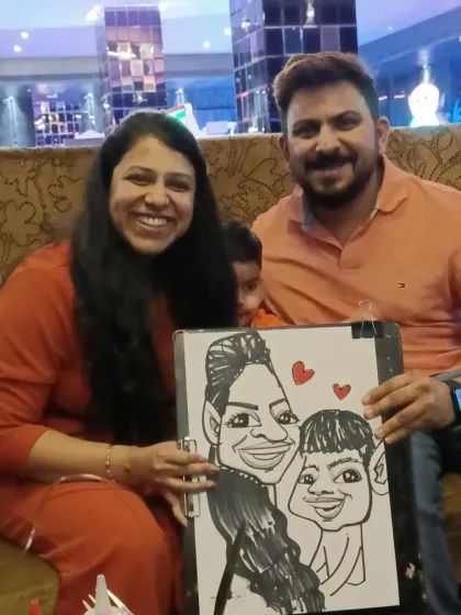 A family from the TAO Architects event with their group caricature. It's a wonderful keepsake for employees and their loved ones.