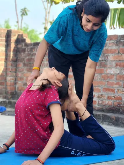 Each time you step onto the mat, it's a chance to grow. Here I am guiding my student into Poorna Bhujangasana, the Full Cobra Pose, which helps keep the spine wonderfully supple and healthy.