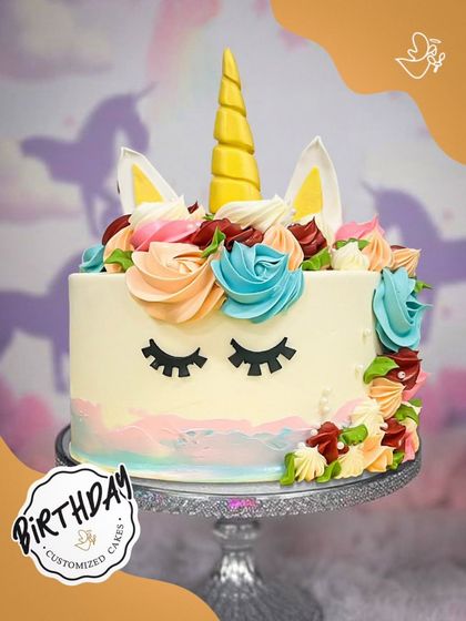 A dreamy unicorn cake with sleepy eyes and a crown of colorful buttercream roses. This elegant and cute design is a popular choice for magical birthday celebrations.