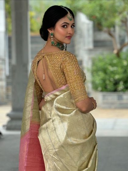 This antique gold blouse features a deep back and delicate tie-up detail. The entire surface is hand-embroidered, creating a rich texture that pairs beautifully with a classic silk saree for a reception or festive event.
