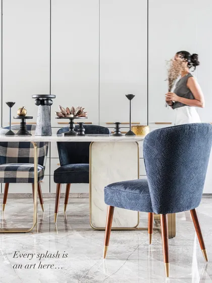 In this dining space, every splash is an art. We mixed textures and styles, pairing plush blue velvet chairs with a classic plaid, all centered around a marble and brass table. It’s a design that celebrates both harmony and individuality, creating a setting that is both elegant and inviting.