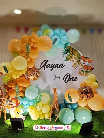 A cute and friendly jungle theme for Aayan's first birthday. This design features cartoon animal cutouts, a personalized backdrop, and a colorful balloon arch with tropical leaf accents.