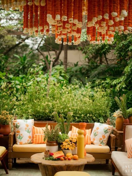 A seating area under a canopy of marigold garlands at the 'Kesar Sehar' Haldi. The design celebrated the beauty of Indian flowers and the auspiciousness of the Haldi ceremony.