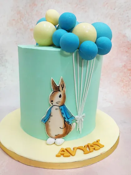 Another angle of our Peter Rabbit cake, set against a soft mint green frosting that evokes a meadow feel.