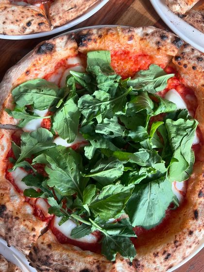 Pizza on our mind, all day, everyday. This one is topped with fresh mozzarella, arugula, and basil.