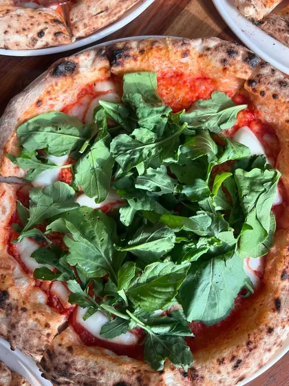 Pizza on our mind, all day, everyday. This one is topped with fresh mozzarella, arugula, and basil.