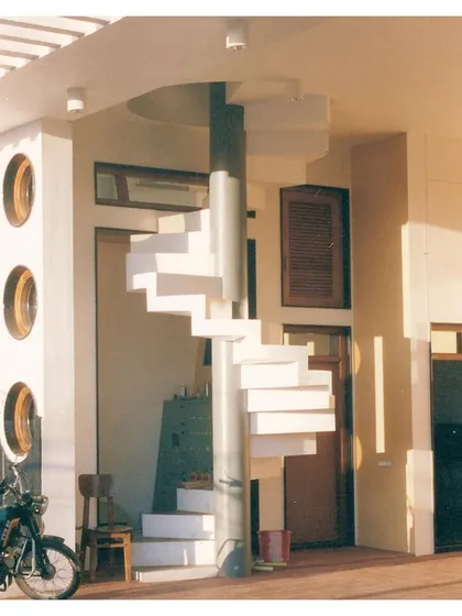 The completed CC Office, featuring a sculptural spiral staircase that serves as a central design element in the transitional space between inside and outside.