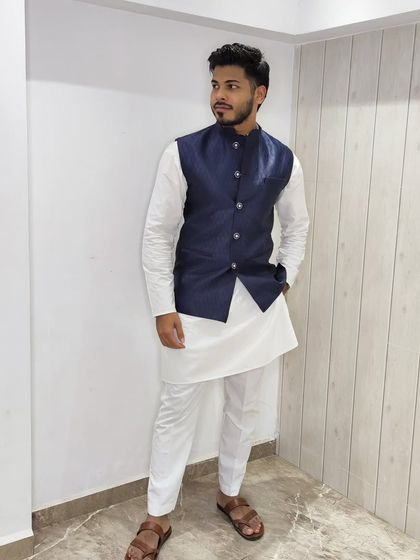 A full-length view of the client in the navy blue jacket and white kurta, a versatile and stylish ensemble.