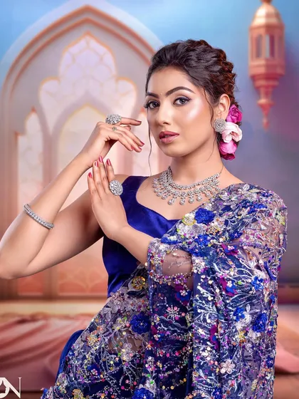 A confident pose showcasing the full effect of this drugstore-product look. The makeup is flawless and the styling is on point.