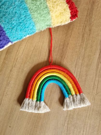 A classic macrame rainbow car hanging, bringing a spectrum of color and joy to your journey. This piece is a simple yet powerful reminder of creativity and happiness.