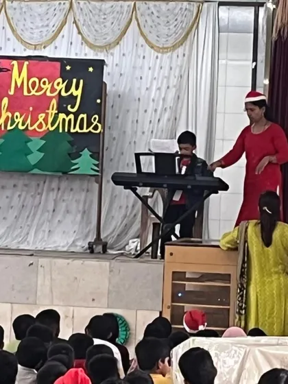 Our young musician, Aaden Fernandes, performs Christmas carols for his entire school at St. Anthony's High School. He confidently played the keyboard for a large audience, spreading holiday cheer.