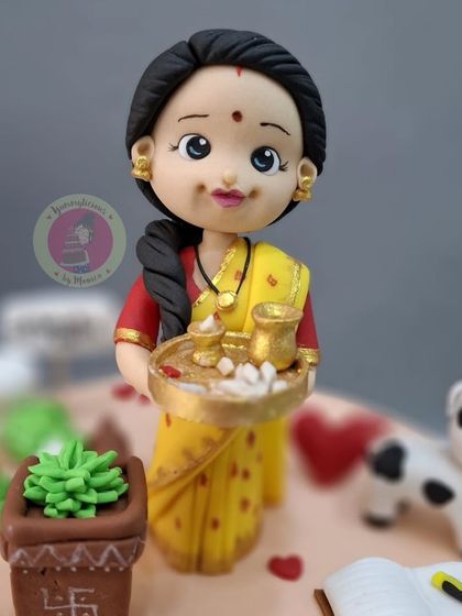 A close-up of the Rupali Ganguly "Anupamaa" figurine, complete with a puja thali. Capturing her iconic look was a rewarding challenge.