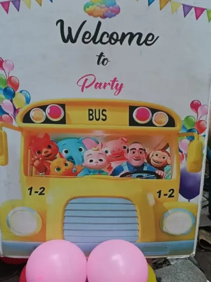 A Cocomelon-themed welcome sign for a birthday party. This fun prop, featuring characters on a yellow bus, is a great way to greet young guests.