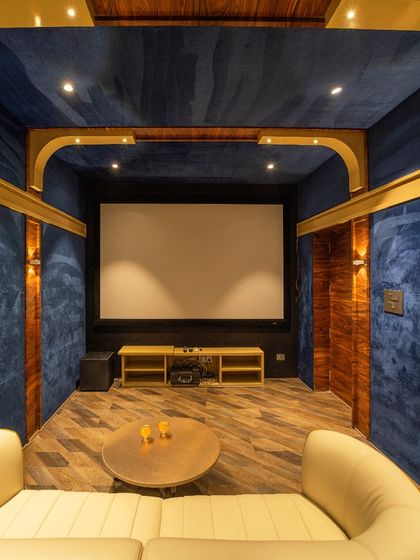 The view towards the projector screen, showing the clean, integrated design of the entertainment system.