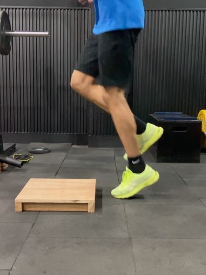 A close-up of a plyometric box drill, focusing on the quick ground contact time needed to develop reactive strength.