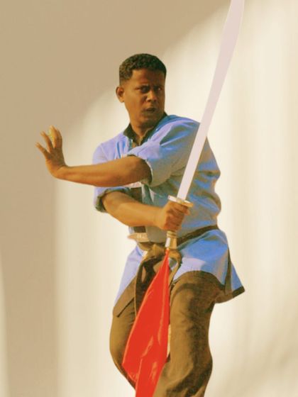 A full-body shot from 2007, demonstrating a sword form. The art of weapons has been a part of my practice for many years.