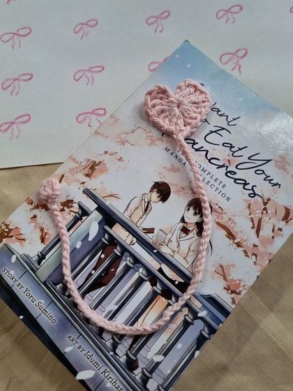 A full view of the pink heart bookmark. It's a simple yet lovely design that makes a great gift for any book lover.